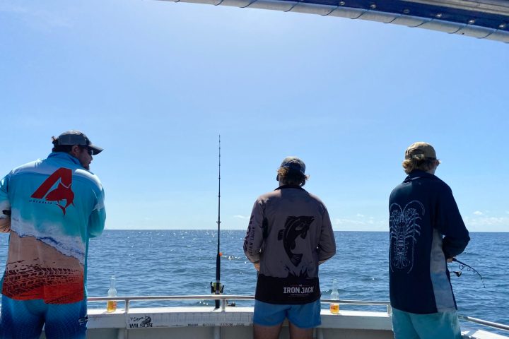 a group of people standing on a boat