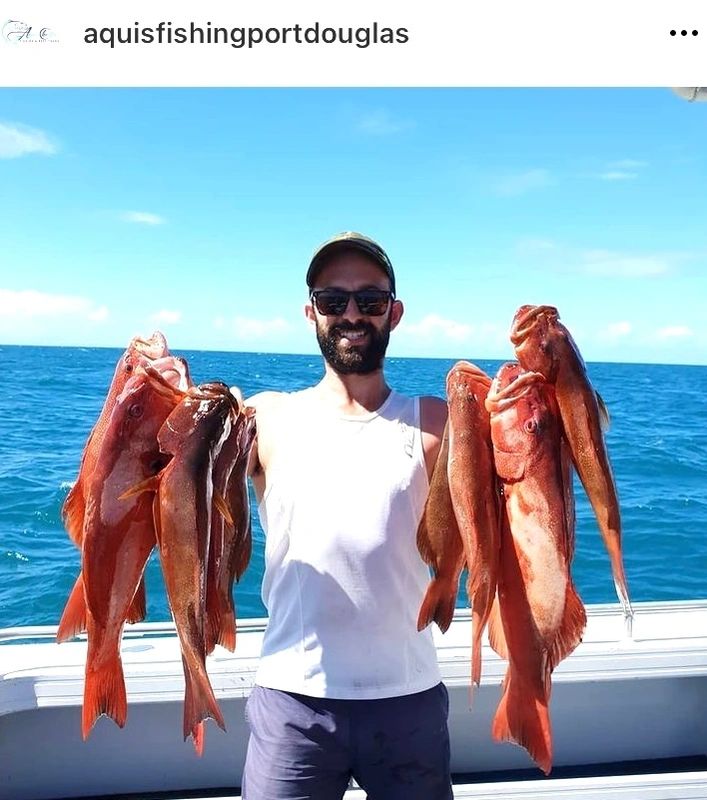 a person holding a fish in the water