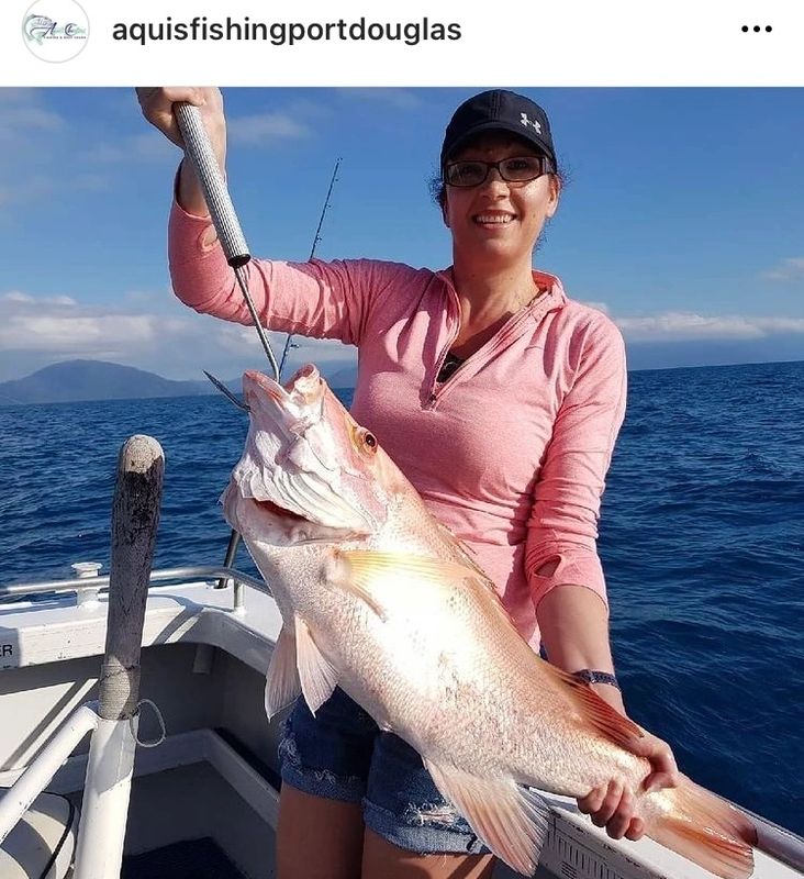 a person holding a fish in the water