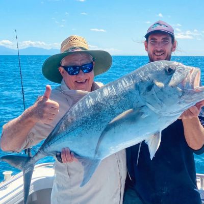 a person holding a fish swimming under water